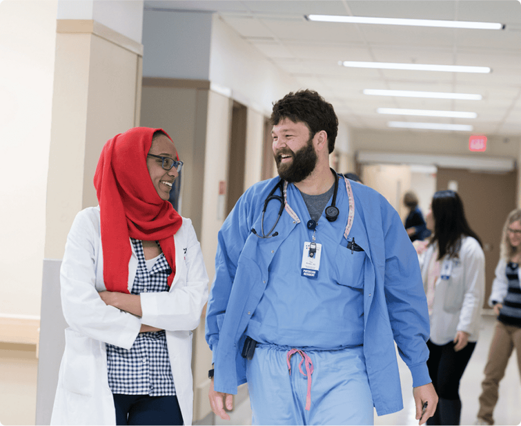 two residents walking in internal medicine inpatient hallway