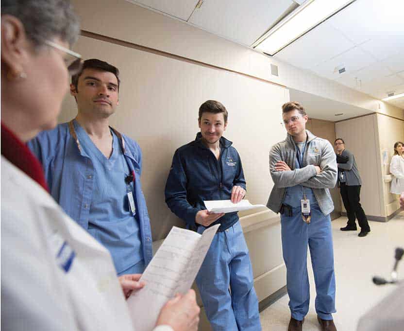 nephrology residents rounding in hallway with chief