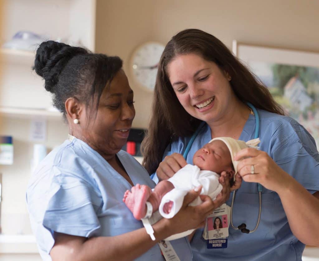 two providers with newborn baby in birth center