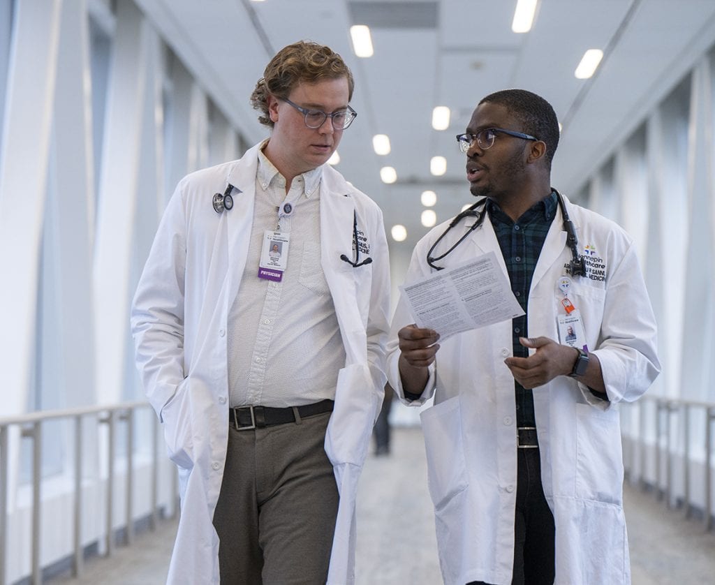 two residents talking in skyway